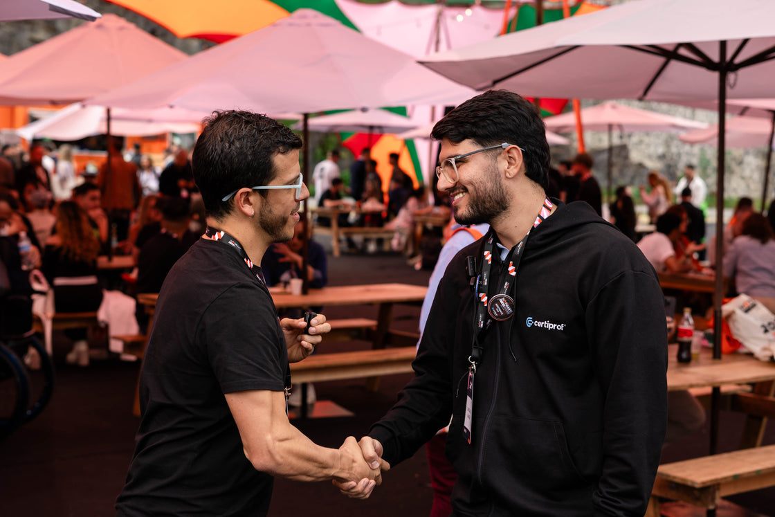 CertiProf team member greeting a training partner at an event